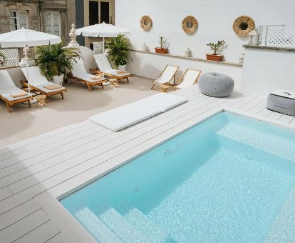 Acogedora terraza con tumbonas y piscina de este hotel solo para adultos.