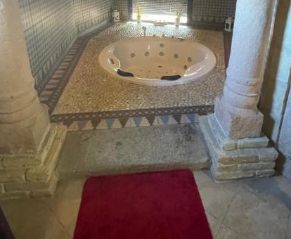 Foto del baño con jacuzzi privadoo decorado con pétalos de rosa que se encuentra en la Posada Los Cantaros de Pizarra
