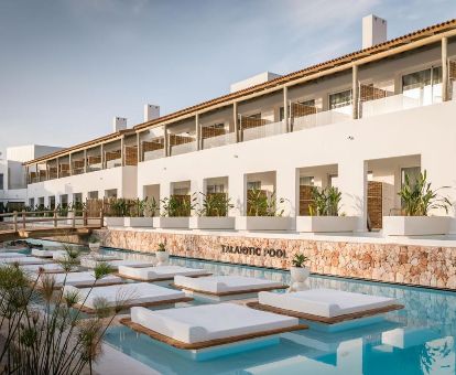 Romántico hotel con piscina al aire libre y camas sobre el agua ideal para parejas.
